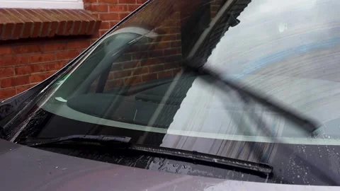 Video of wipers cleaning the windshield of a car with washer fluid. Stock Footage 341681836