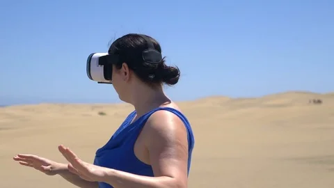 Video of woman exploring virtual reality on the desert in 4k slow motion Stock Footage 80224622