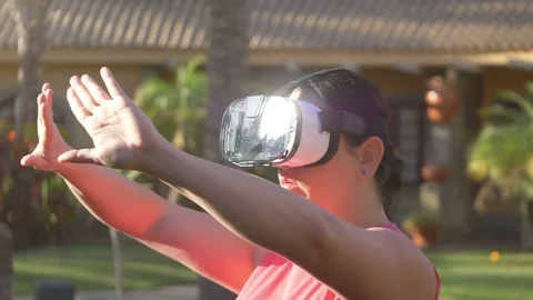 Video of woman exploring virtual reality in tropical resort in 4k Stock Footage 80231454
