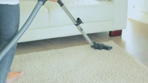 Video of woman vacuuming the carpet Stock Footage