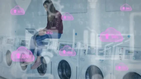 Video of woman working on laptop while waiting at laundromat with cloud Stock Footage 329692368