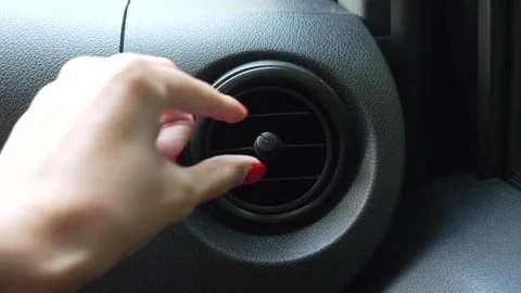 Video of a woman's hand adjusting the air vent Stock Footage 345172887