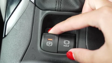 Video of a woman's hand pressing the parking button Stock Footage 345012529