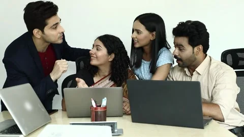 Video of Work collogues looking at laptop screen while discussing about project. Stock Footage 244124880