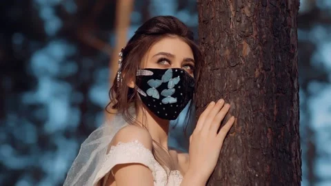 A video with a young bride. On her face she has a black mask with blue. Stock Footage 131767595