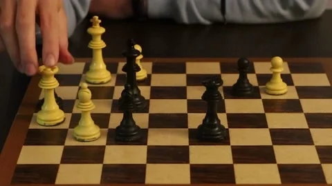 Video of a young man performing a chess move that ends in checkmate Stock Footage 151555444