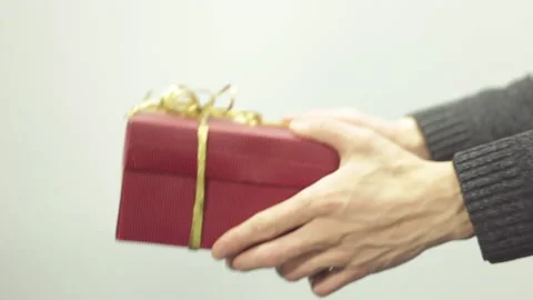 Video of a young man on a white background giving to the woman a wonderful .. Stock Footage 233459366
