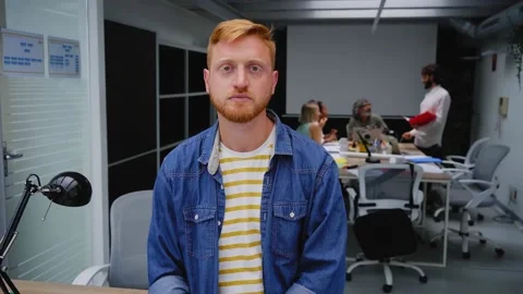 Video young red-haired programmer or businessman in modern office looking Stock-Footage 234018189