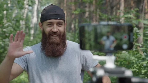 Videoblog athlete: hipster does the exercises, shooting on the camera Stock Footage 92840159