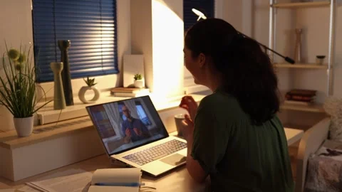 Videocall. Online working. Back view of Young Caucasian woman works at laptop Stock Footage 250852036