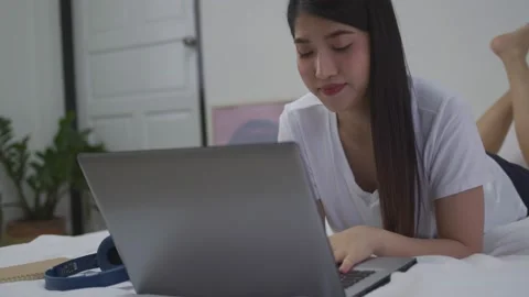 Videoconferencing in the workplace. In her home office, an Asian woman is on  Stock Footage 165635287
