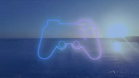 Videogame controller icon against view of sunset sky over the sea Stock Footage 329364332