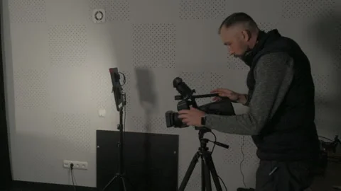 Videographer adjusting  on a professional video camera Stock Footage 335141352