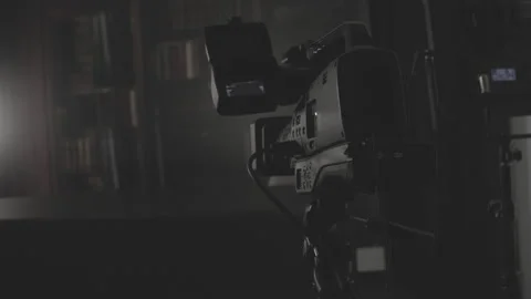 Videographer adjusting  on a professional video camera Stock Footage 335141392