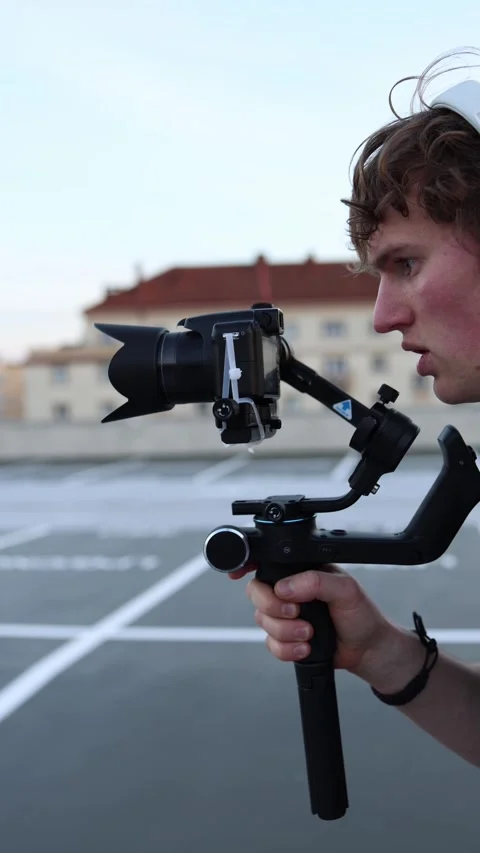 Videographer aligning camera on stabilizer Stock Footage 332116769