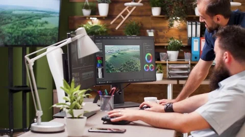 Videographer and senior editor working together on a project Stock Footage 110478210