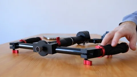 Videographer are testing convenience of a new innovative three-axis stabilizer Stock Footage 99641265