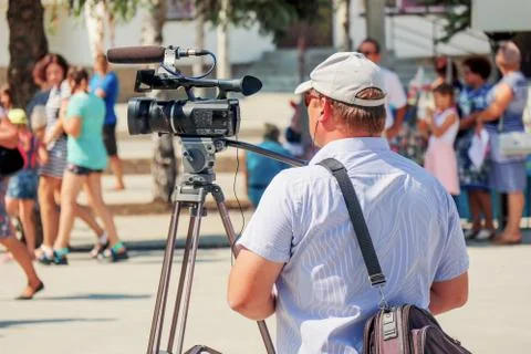 Videographer with a camera at work Photos
