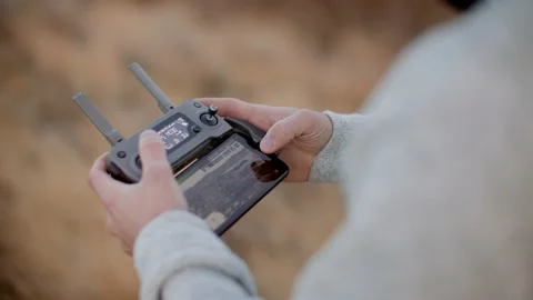 Videographer captures city on drone remote controller 库存影片 209351380