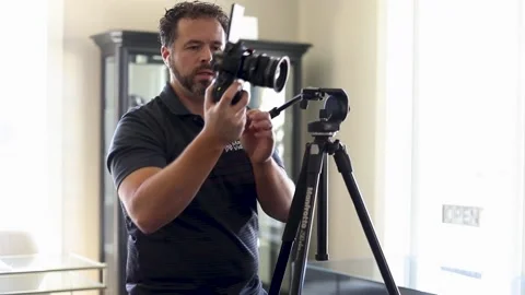 Videographer is changing battery of the camera Video stock 131549849