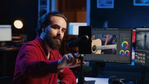 Videographer filming online tutorial with phone about utilizing editing software Stock Photos