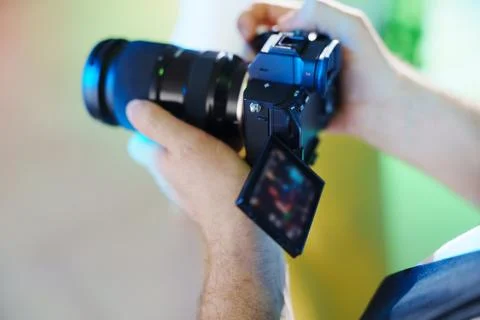 Videographer hands with camera and flip screen Stock Photos