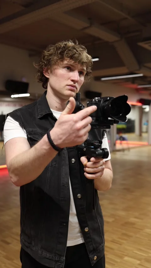 Videographer makes funny faces with camera on gimbal Stock Footage 332116666