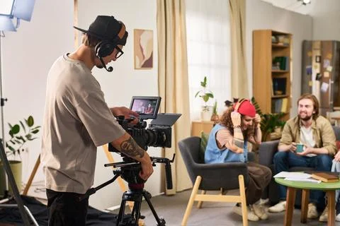 Videographer Operating Camera Filming Talk Show in Studio Stock Photos