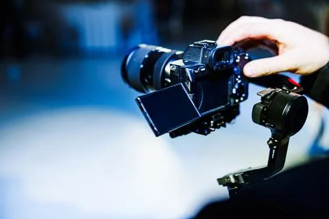 Videographer operating gimbal stabilizer Stock Photos