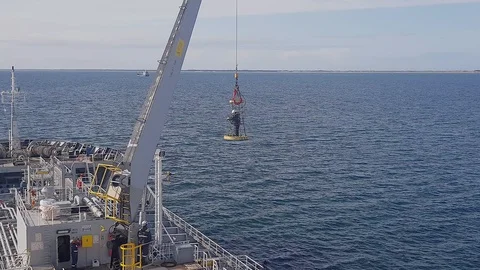 Videographer performs video shooting standing in basket Stock Footage 121116646