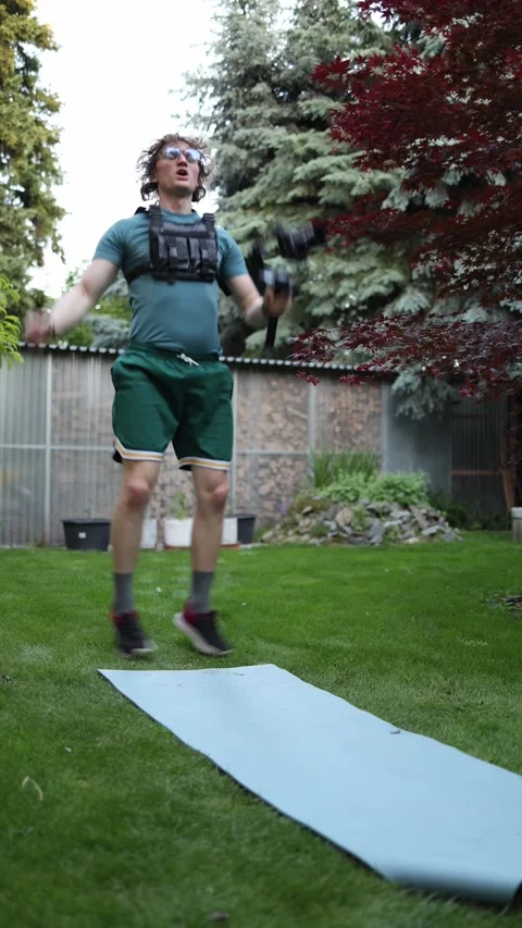 Videographer practicing explosive jumps with camera gimbal Stock Footage 336371058