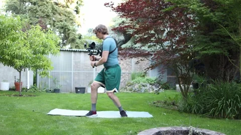 Videographer practicing gimbal movement for stable footage Stock Footage 336791378