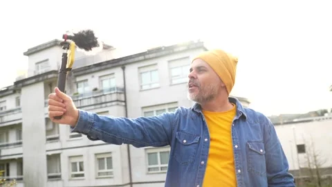 Videographer recording outdoors using gimbal Stock Footage 295764933