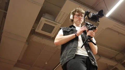 Videographer sets camera on gimbal Video stock 332902341