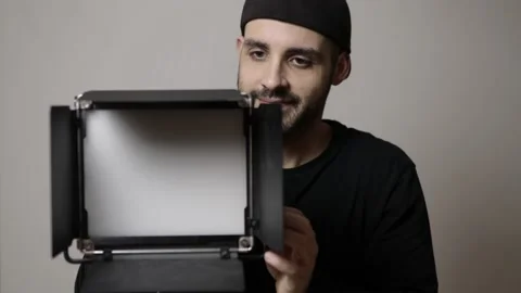 Videographer sets up led panel for shooting video Stock Footage 148658220