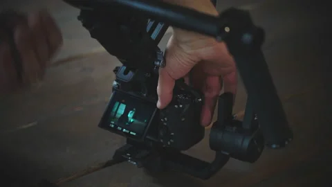 Videographer setting up a camera for a studio shoot. Stock Footage 130804039