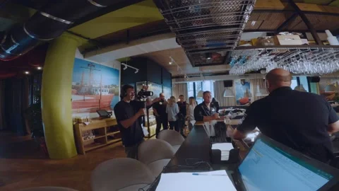A videographer shoots a scene in a restaurant 스톡 동영상 201755466
