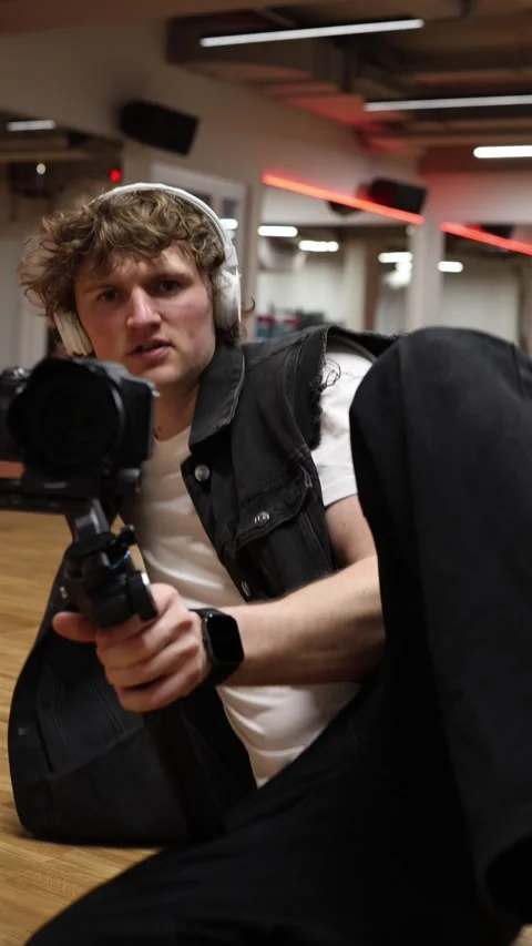 Videographer sliding low with camera stabilizer Stock Footage 332116736