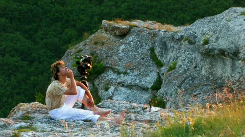 Videographer on sunset mountain HD Stock Footage 478487