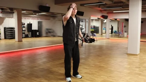 Videographer talking and gesturing in gym studio 스톡 동영상 332116846