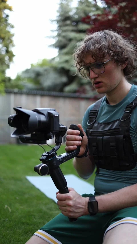 Videographer testing camera gimbal performance outdoors Stock Footage 336370850