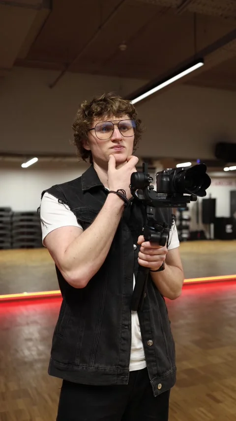 Videographer thinking about shot Video stock 332116686