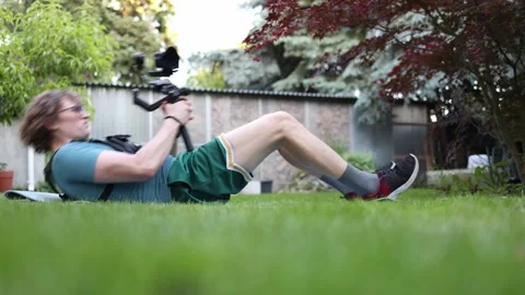 Videographer trains abs with gimbal Stock Footage 336791450