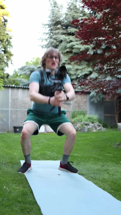 Videographer trains with camera gimbal to improve filming endurance Stock Footage 336369345
