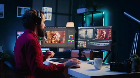 Videographer uses software to create visual effects for video projects while Stock Footage 257725653