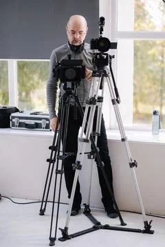 Videographer uses two cameras in parallel to shoot a clip in the studio. News Stock Photos