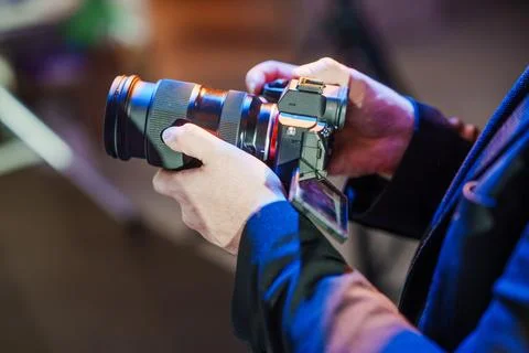 Videographer using flip screen camera at venue Stock Photos