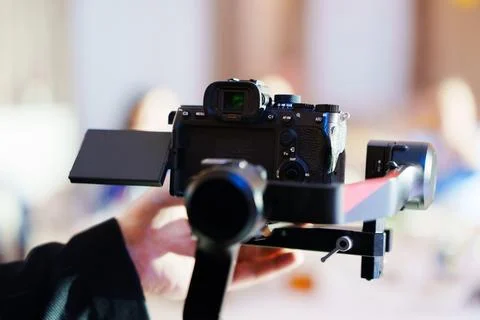 Videographer using gimbal stabilizer for shooting Stock Photos