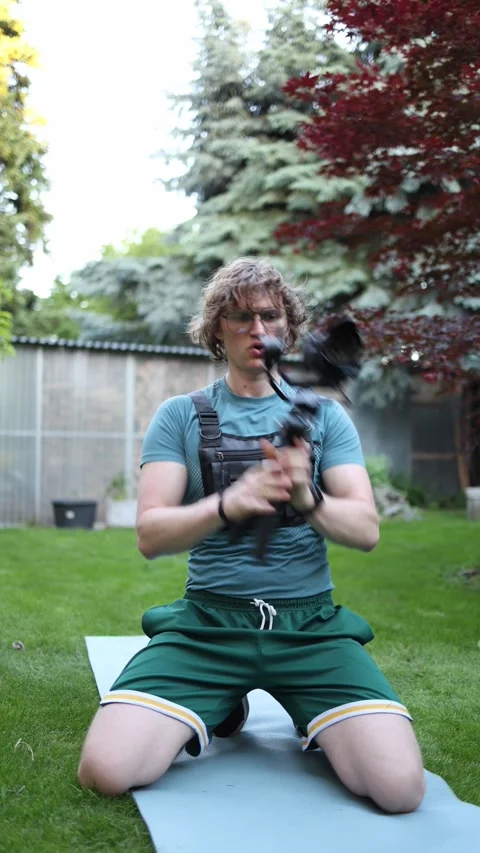 Videographer warms up before a long filming session Stock Footage 336369348