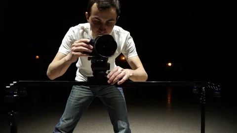 Videographer working with dslr camera, and slider Stock Footage 72548347
